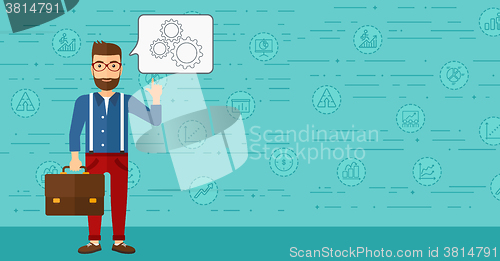 Image of Businessman pointing at cogwheels.