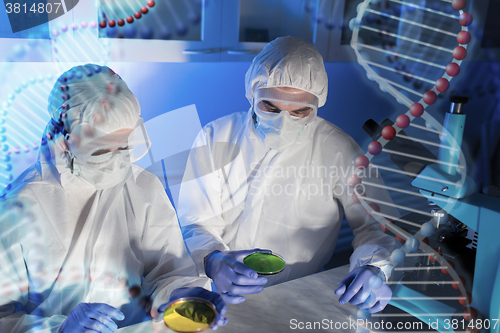 Image of close up of scientists with test samples in lab