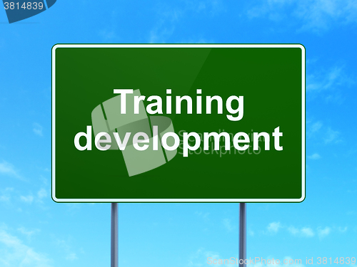 Image of Education concept: Training Development on road sign background