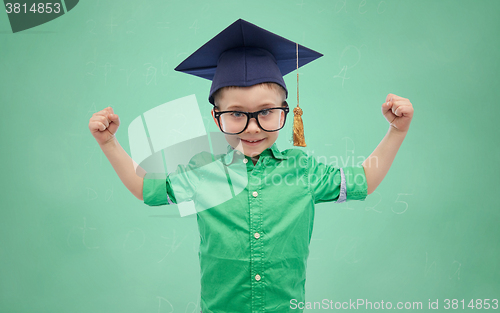 Image of happy boy in bachelor hat showing power