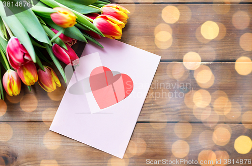 Image of close up of flowers and greeting card with heart