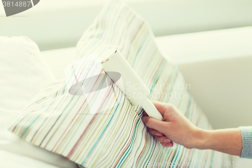 Image of close up of woman hand with sticky roller cleaning