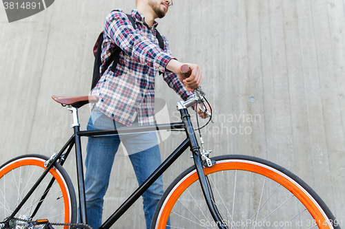 Image of hipster man with fixed gear bike and backpack