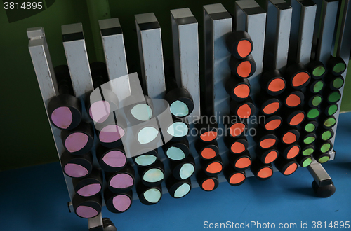 Image of close up of dumbbells and sports equipment in gym