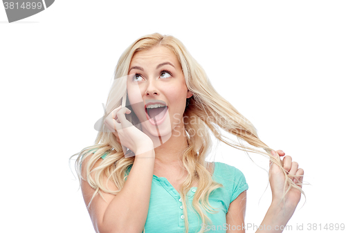 Image of smiling young woman calling on smartphone