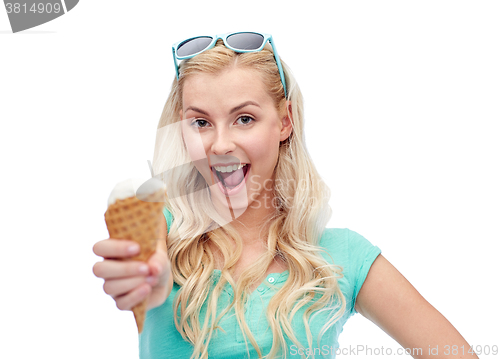 Image of happy young woman in sunglasses eating ice cream