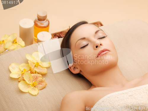 Image of woman in spa salon lying on the massage desk