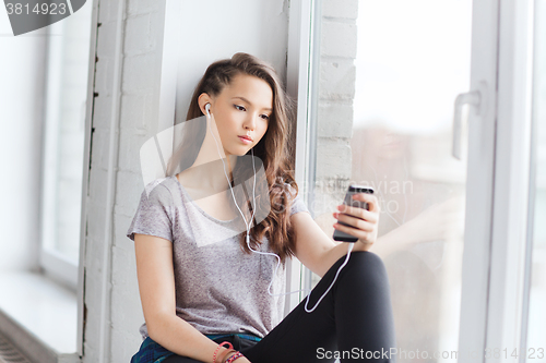 Image of teenage girl with smartphone and earphones