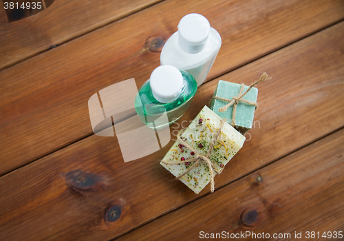 Image of close up of handmade soap bars and lotions on wood