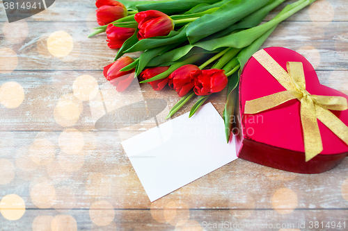 Image of close up of red tulips, letter and chocolate box