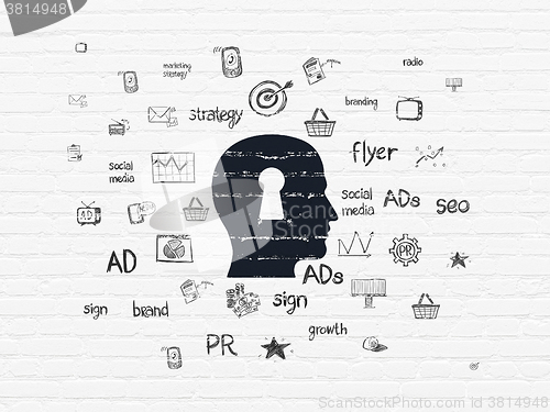 Image of Marketing concept: Head With Keyhole on wall background