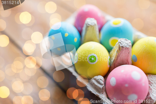 Image of close up of colored easter eggs in egg box