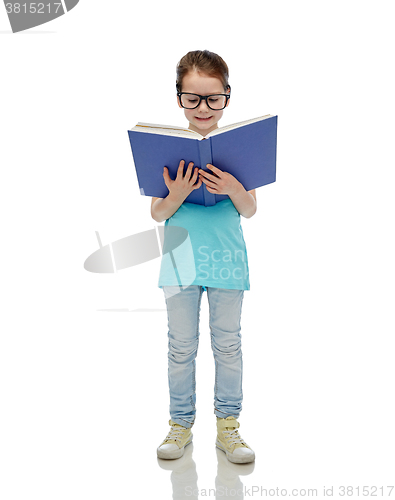 Image of happy little girl in eyeglasses reading book