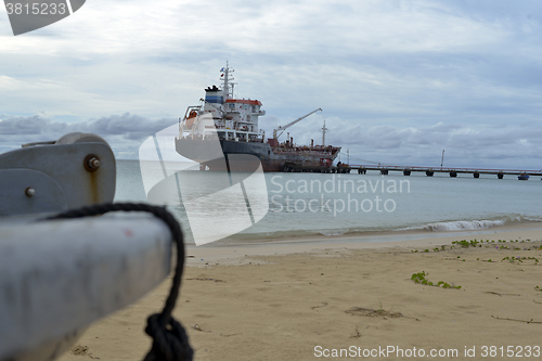 Image of oil tanker vessel at dock with boat bow in foreground  anchor pu