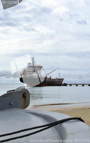 Image of oil tanker vessel at dock with boat bow in foreground  anchor pu