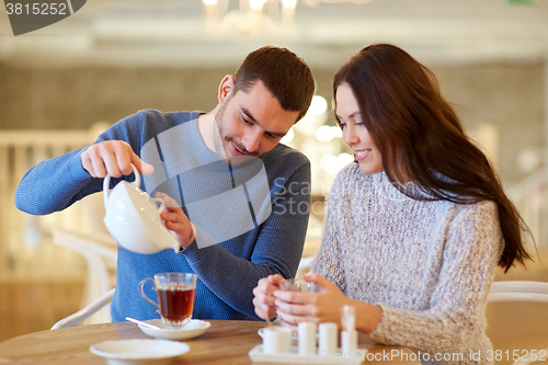 Image of happy couple drinking tea at cafe