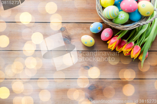 Image of close up of easter eggs in basket and flowers