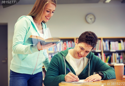 Image of happy students preparing to exams in library