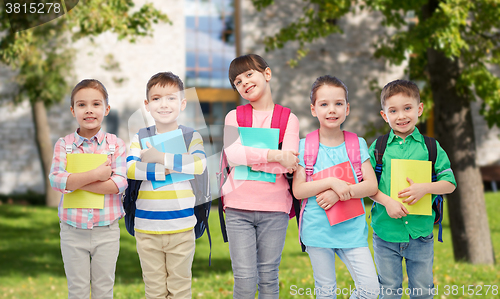 Image of happy children with school bags and notebooks