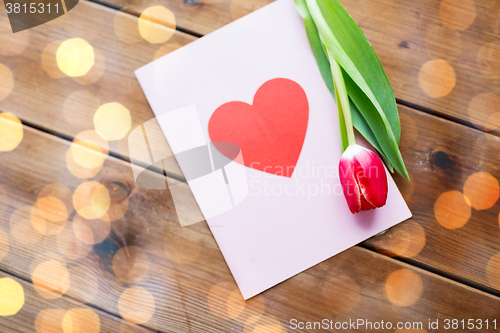 Image of close up of flowers and greeting card with heart