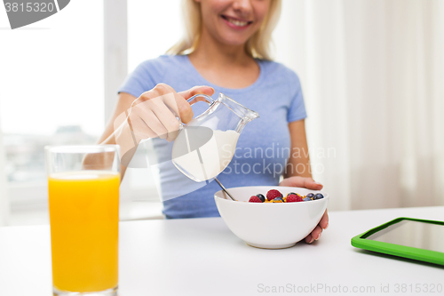 Image of close up of woman with milk jug eating breakfast