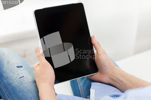 Image of close up of man working with tablet pc at home