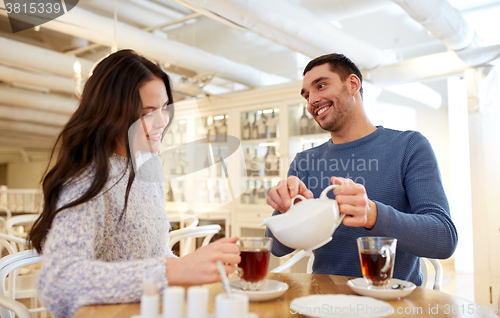 Image of happy couple drinking tea at cafe