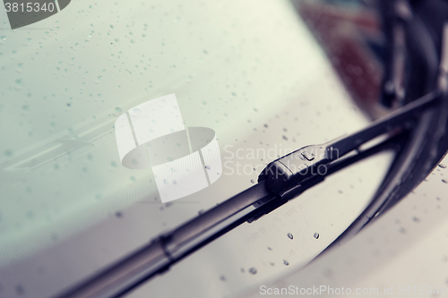 Image of close up of windshield wiper and wet car glass