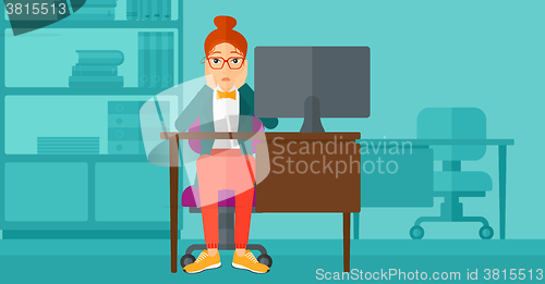 Image of Tired employee sitting in office.