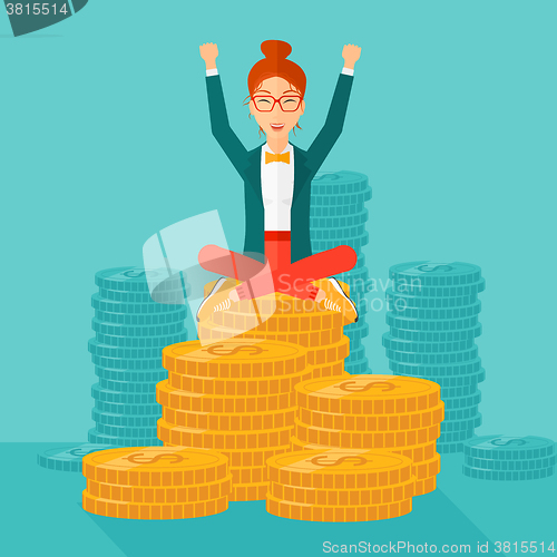 Image of  Happy business woman sitting on coins.