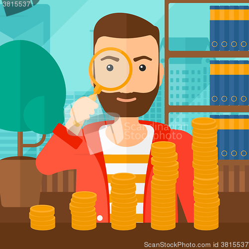 Image of Man with magnifier and golden coins. 