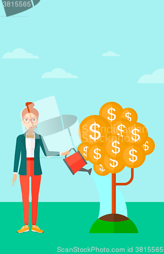 Image of Woman watering money tree.