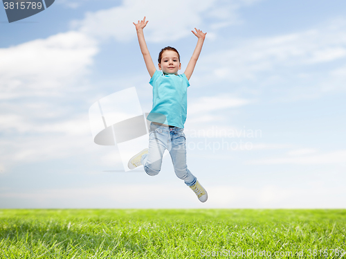 Image of happy little girl jumping in air