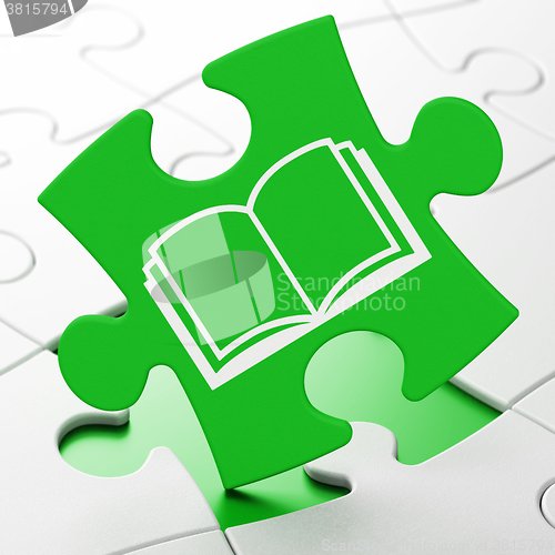 Image of Science concept: Book on puzzle background