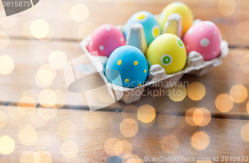 Image of close up of colored easter eggs in egg box