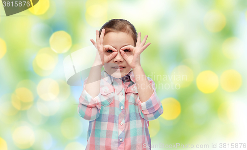 Image of happy little girl making faces and having fun