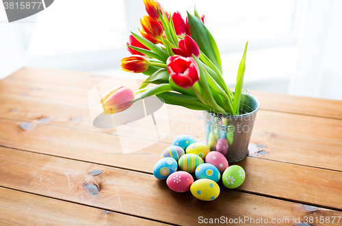 Image of close up of easter eggs and flowers in bucket