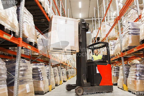 Image of man on forklift loading cargo at warehouse