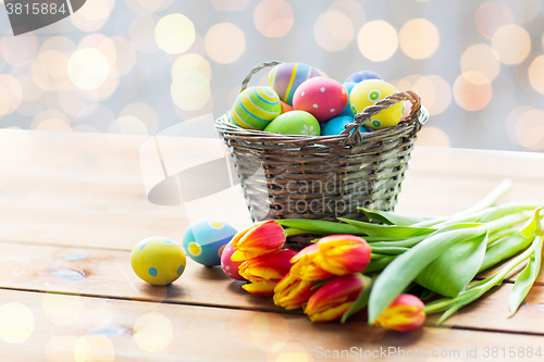 Image of close up of easter eggs in basket and flowers