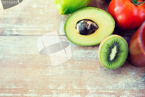 Image of close up of fresh fruits and juice glass on table