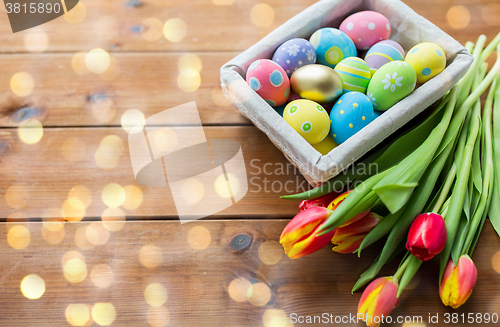 Image of close up of colored easter eggs and flowers