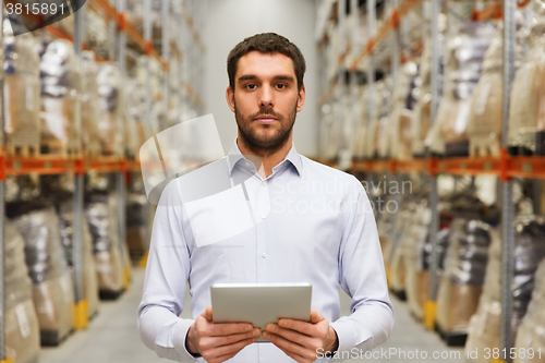 Image of businessman with tablet pc at warehouse