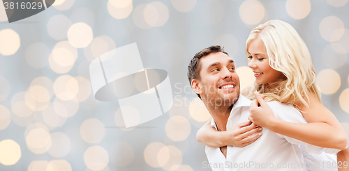 Image of happy couple over holidays lights background