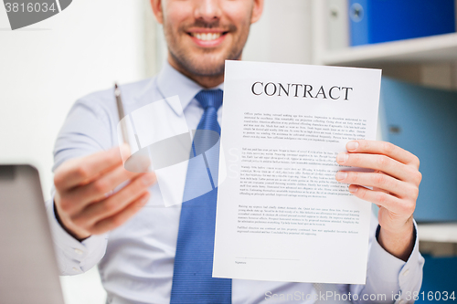 Image of close up of businessman holding contract document