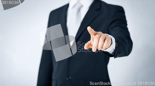 Image of close up of man pointing finger to something