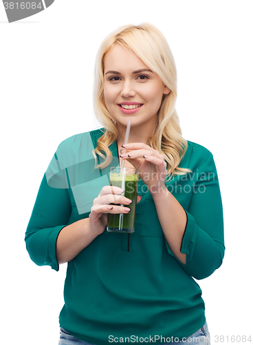 Image of smiling woman drinking vegetable juice or smoothie