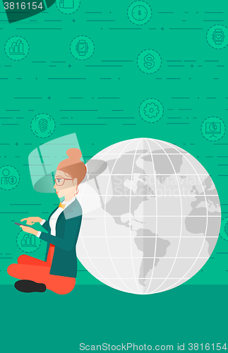 Image of Woman sitting near globe.