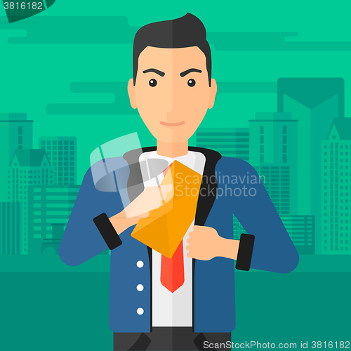 Image of Man putting envelope in pocket.