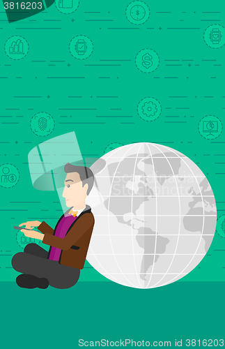 Image of Man sitting near globe.