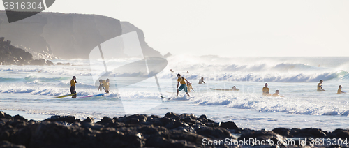 Image of Surfers surfing on El Cotillo beach, Fuerteventura, Canary Islands, Spain.